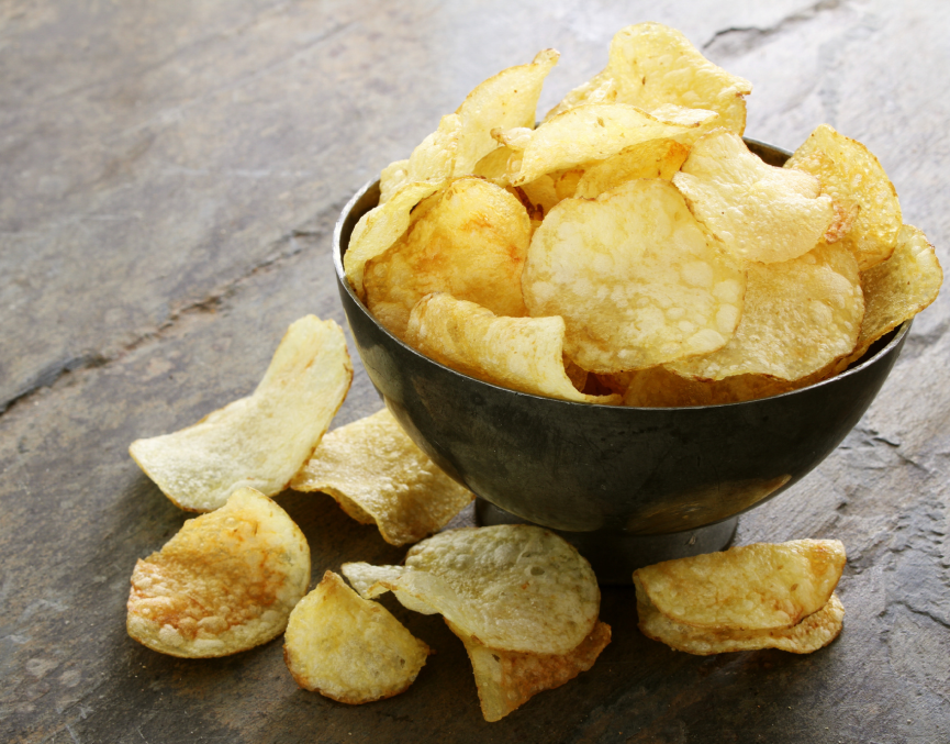 A bowl of Made For Drink's light and crunchy English Heritage Dorset Sea Salt potato crisps on a slate table