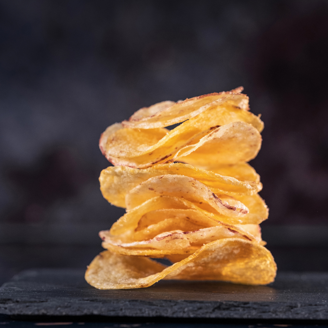 A stack of Made For Drink's Dorset Sea Salt Crisps.