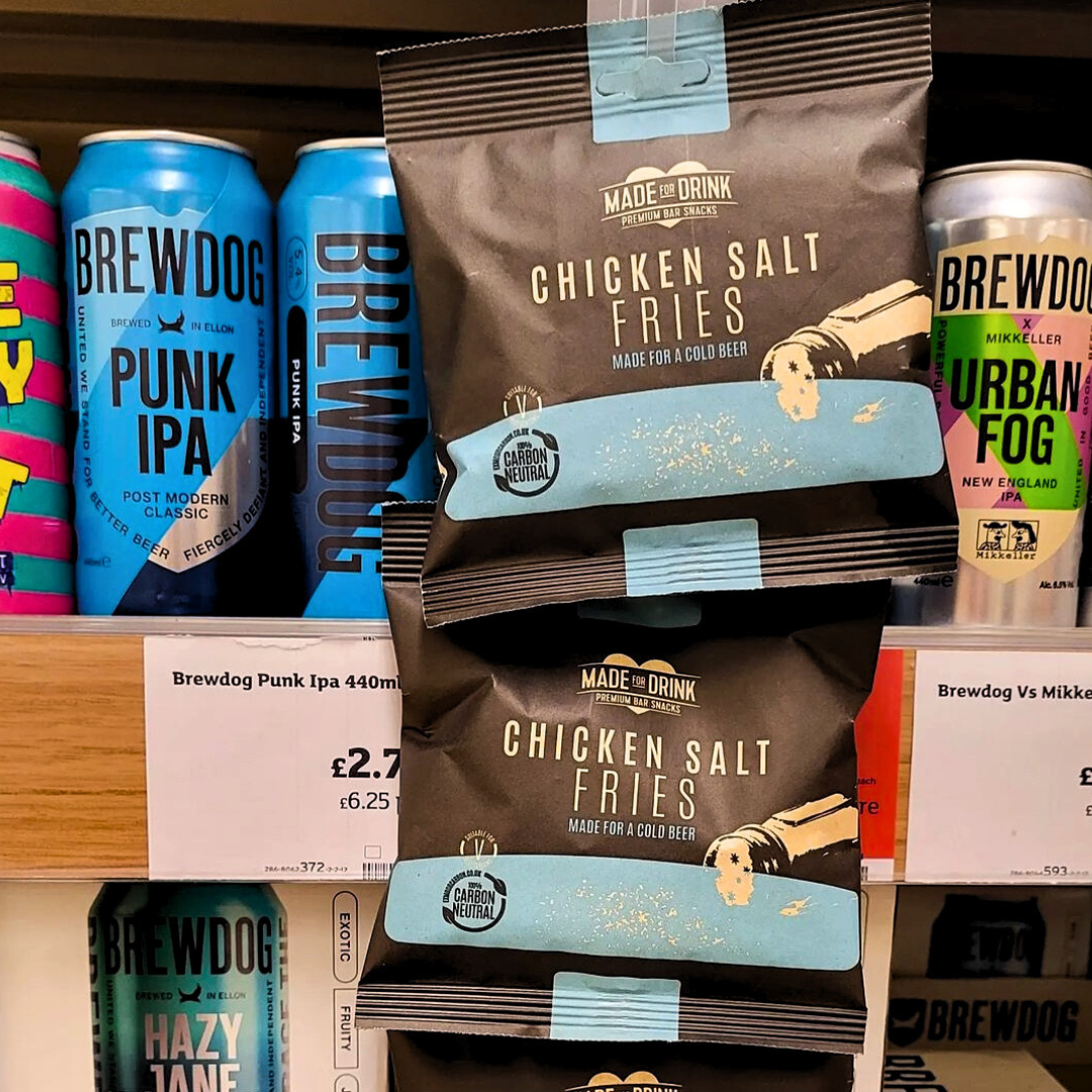 40g packs of Made For Drink's Chicken Salt Fries hanging on clip strips in a supermarket drinks aisle alongside beer.